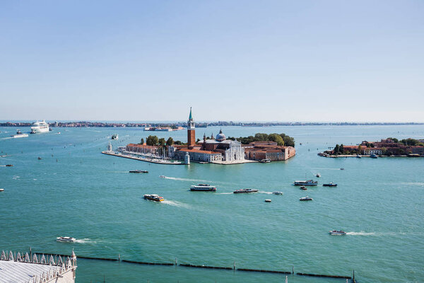 San Giorgio Maggiore island and motor boats floating on river in Venice, Italy 