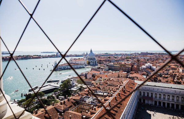 high angle view of Piazza San Marco, river, Santa Maria della Salute church and ancient buildings in Venice, Italy 