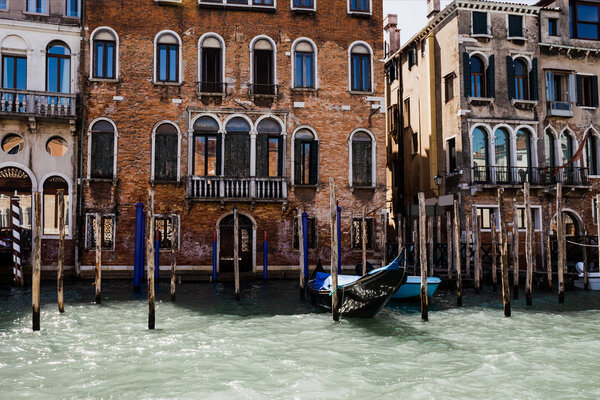 canal with gondola and ancient building in Venice, Italy 