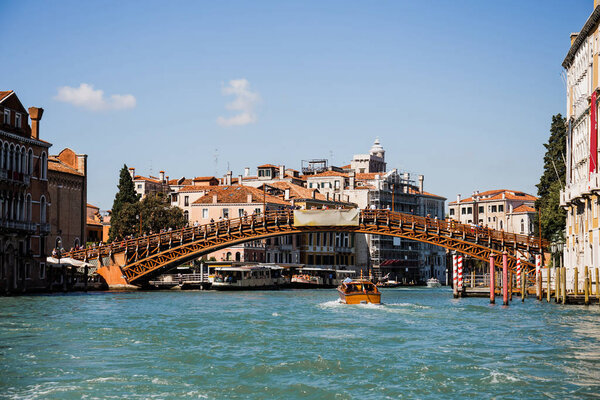 VENICE, ITALY - SEPTEMBER 24, 2019: vaporetto floating under Accademia bridge in Venice, Italy 