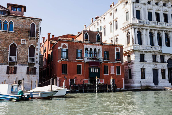 river with motor boats near ancient buildings in Venice, Italy 