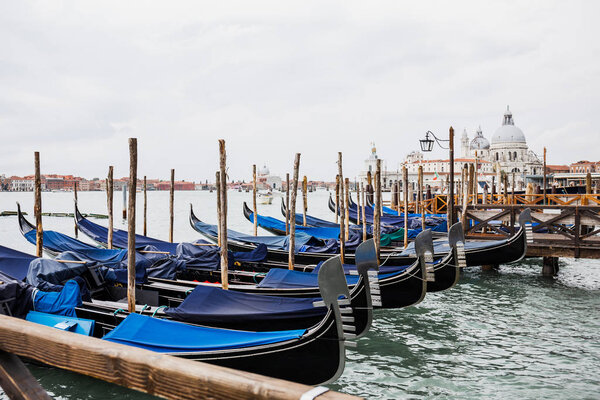river, blue gondolas and Santa Maria della Salute in Venice, Italy 