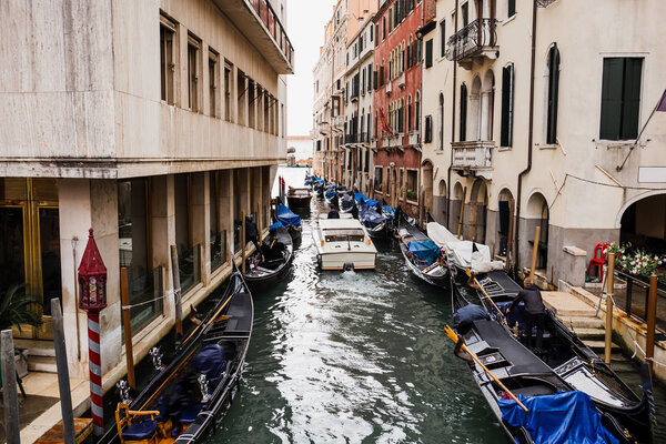 VENICE, ITALY - SEPTEMBER 24, 2019:motor boat floating on canal near ancient buildings in Venice, Italy 