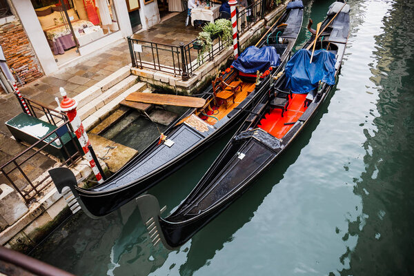 VENICE, ITALY - SEPTEMBER 24, 2019: high angle view of gondolas and canal in Venice, Italy 