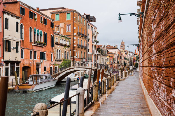 canal, vaporetto near bridge and ancient building in Venice, Italy 