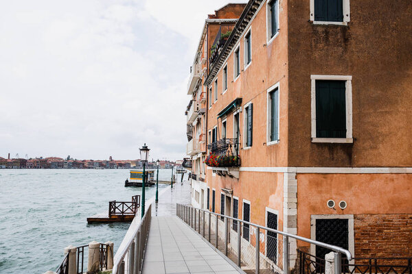 road between ancient building and canal in Venice, Italy 