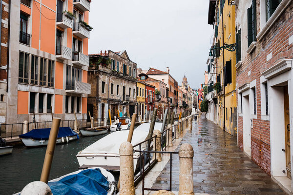 canal, motor boats and ancient buildings in Venice, Italy 
