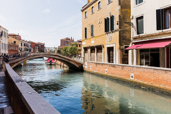 VENICE, ITALY - SEPTEMBER 24, 2019: bridge above canal and ancient buildings in Venice, Italy 