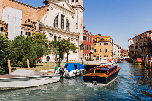 VENICE, ITALY - SEPTEMBER 24, 2019: vaporetto floating on canal near ancient buildings in Venice, Italy 