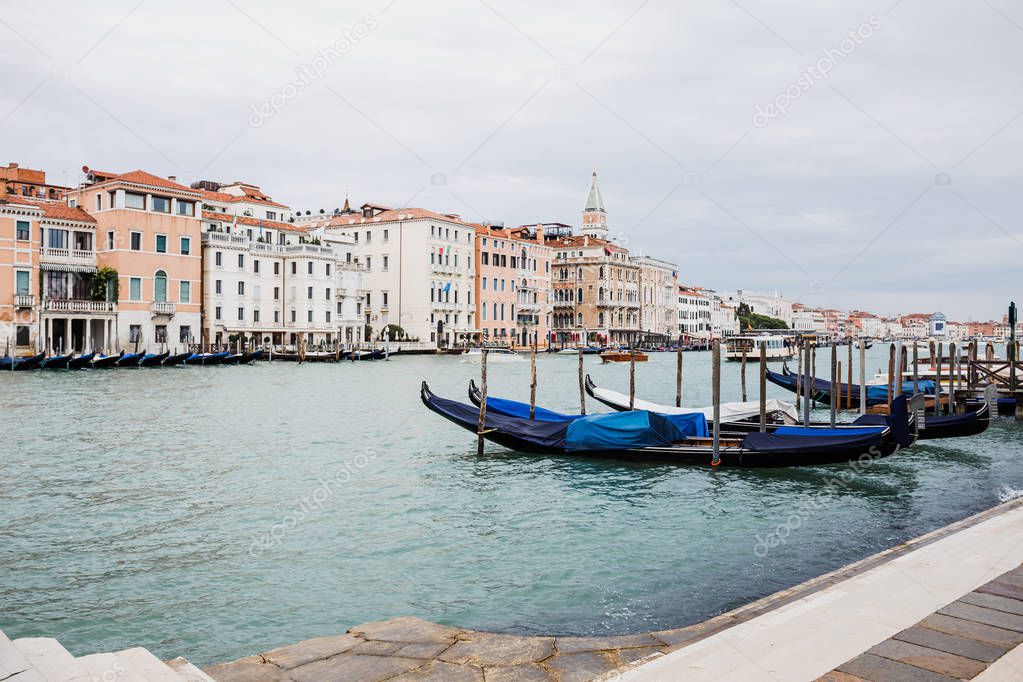 canal with gondolas and ancient buildings in Venice, Italy 