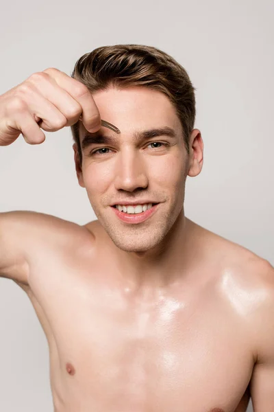 Sonriente Sexy Hombre Con Torso Desnudo Pellizcando Cejas Con Pinzas —  Fotos de Stock