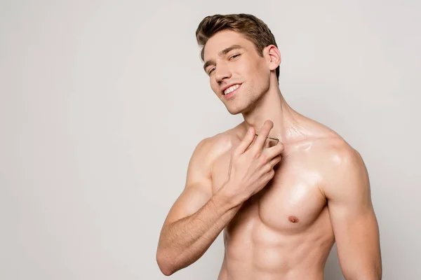 Sorrindo Homem Sexy Com Torso Muscular Pulverização Perfume Isolado Cinza — Fotografia de Stock