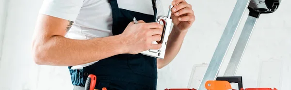 Panoramic Shot Installer Holding Construction Stapler — Stock Photo, Image