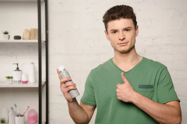 Positive Young Man Green Shirt Showing Thumb While Holding Deodorant — Stock Photo, Image