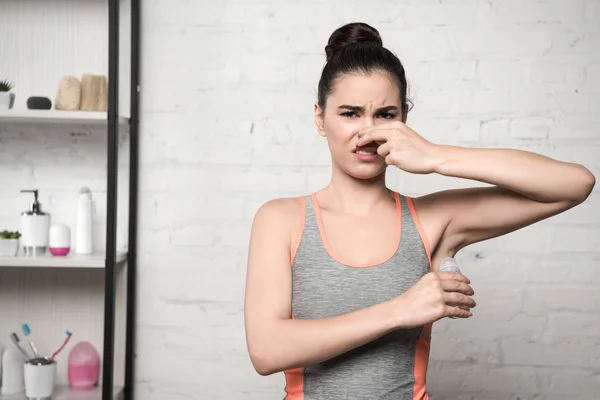 Shocked Woman Plugging Nose Hand While Applying Deodorant Underarm — 스톡 사진