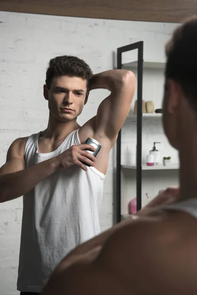 Young Man White Sleeveless Shirt Applying Deodorant Underarm While Looking — Stock Photo, Image