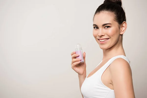 Cheerful Woman Smiling Camera While Holding Deodorant Isolated Grey — Stock Photo, Image