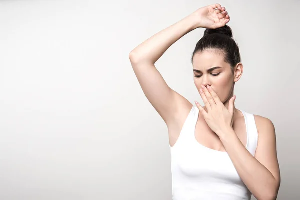 Shocked Woman Looking Underarm Covering Mouth Hand Isolated Grey — Stock Photo, Image