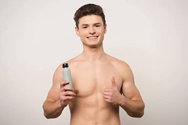 Usmívající Muž Bez Košile Ukazující Palec Nahoru Zatímco Drží Deodorant — Stock fotografie