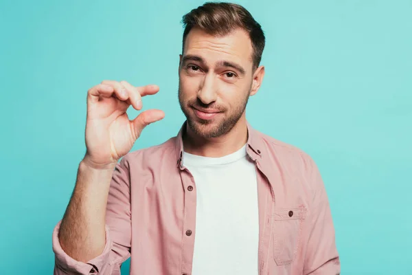 Happy Handsome Man Showing Small Size Sign Isolated Blue — Stock Photo, Image