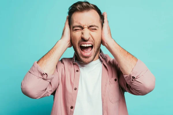 Angry Man Shouting Closing Ears Isolated Blue — Stock Photo, Image