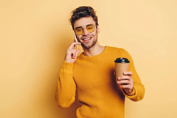 Smiling Man Talking Smartphone While Holding Coffee Yellow Background — Stock Photo, Image