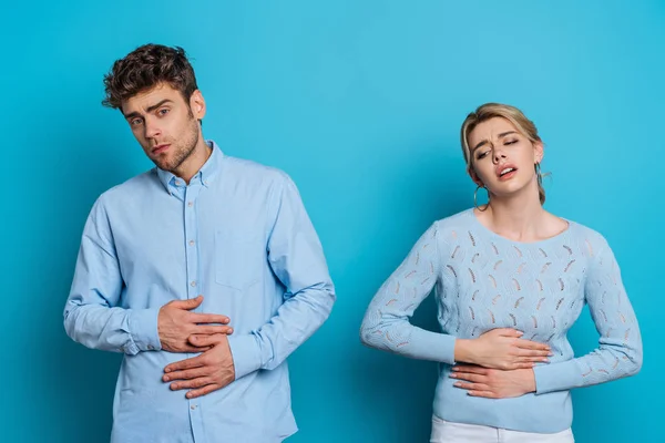 Upset Man Woman Touching Stomachs While Suffering Abdominal Pain Blue — Stock Photo, Image