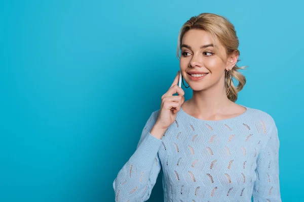 Smiling Girl Looking Away While Talking Smartphone Blue Background — Stock Photo, Image
