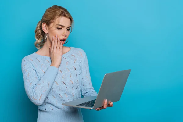 Shocked Girl Touching Face While Looking Laptop Blue Background — 스톡 사진