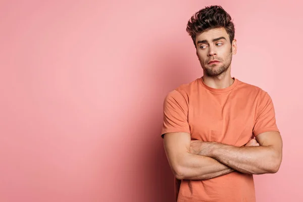 Offended Young Man Standing Crossed Arms Looking Away Pink Background — Stock Photo, Image