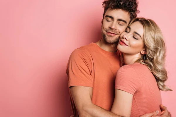 Happy Young Couple Embracing Closed Eyes Pink Background — 스톡 사진