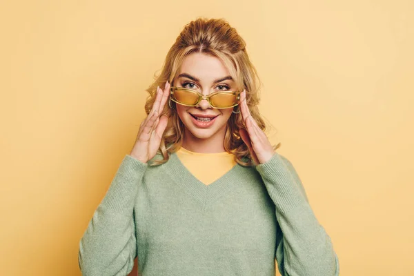 Smiling Girl Touching Glasses While Looking Camera Yellow Background — Stock Photo, Image