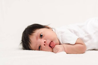adorable bi-racial newborn baby lying isolated on white  clipart
