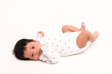 adorable mixed race newborn in baby romper lying isolated on white  clipart