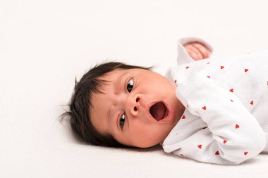 adorable mixed race newborn in baby romper yawning isolated on white  clipart