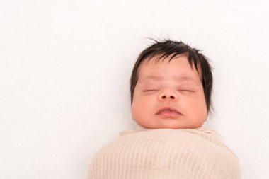 top view of mixed race baby wrapped in blanket sleeping isolated on white  clipart