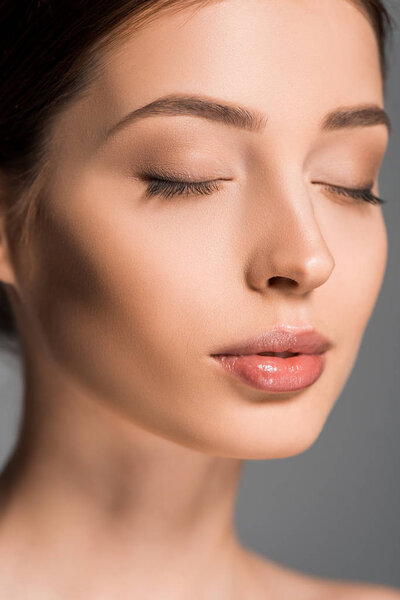 portrait of beautiful girl with closed eyes, isolated on grey