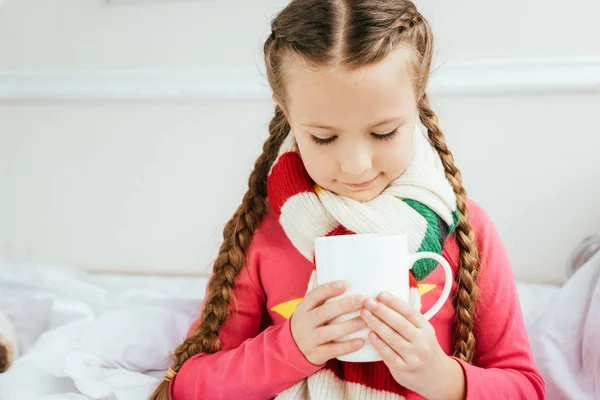 Cute Ill Kid Scarf Holding Cup Hot Drink While Sitting — Stock Photo, Image