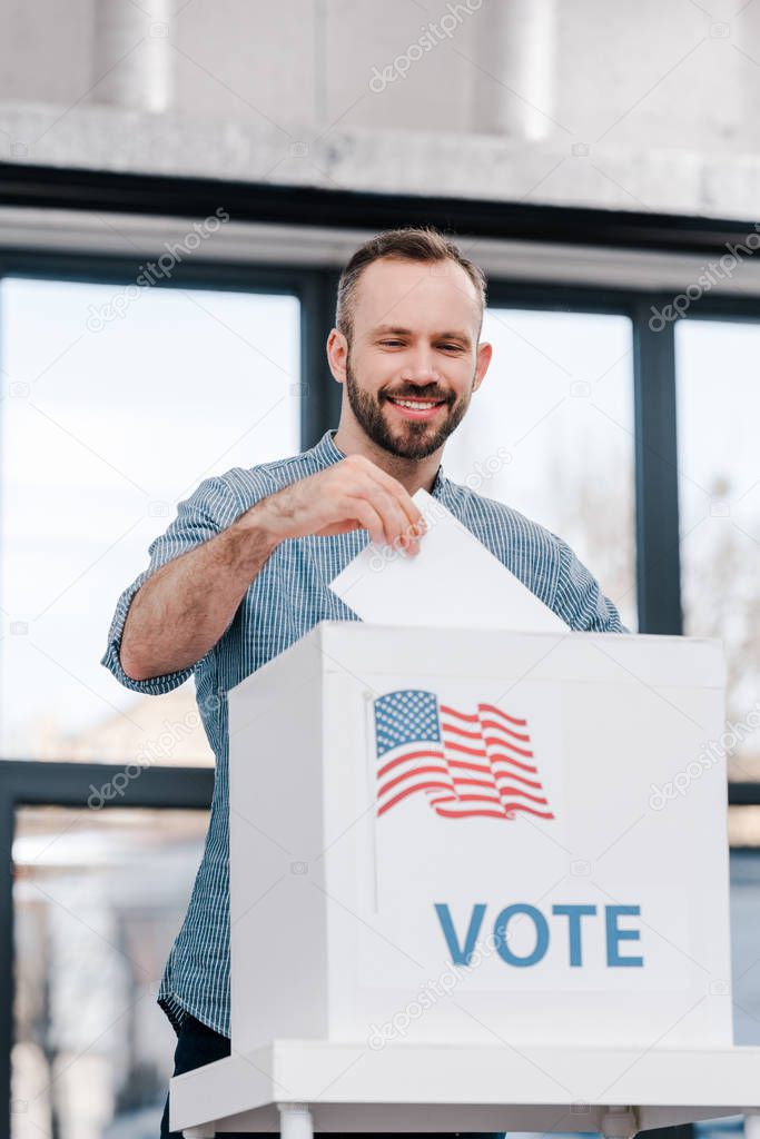 happy bearded man voting and putting ballot in box with vote lettering 