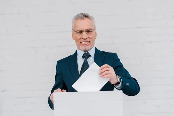 Cheerful Businessman Glasses Voting Brick Wall — Stock Photo, Image