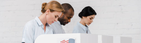 panoramic shot of women and african american man voting near brick wall 