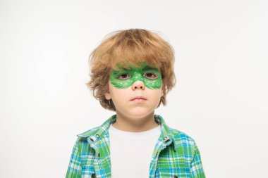  serious boy with gecko mask painted on face looking at camera isolated on white clipart