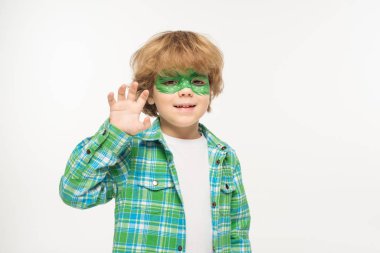 smiling boy with gecko mask painted on face waving hand at camera isolated on white clipart