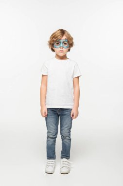 full length view of adorable boy with superhero mask painted on face looking at camera on white background clipart