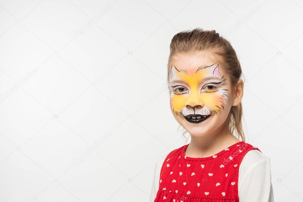 adorable kid with tiger muzzle painting on face smiling at camera isolated on white