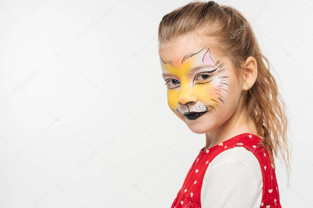 adorable kid with tiger muzzle painting on face looking at camera isolated on white