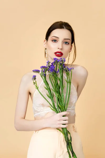 Beautiful Woman Holding Purple Flowers Isolated Beige — Stok fotoğraf