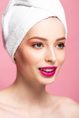 happy naked woman in towel looking away isolated on pink 