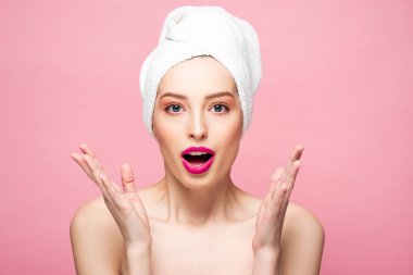 shocked naked woman gesturing and looking at camera isolated on pink 