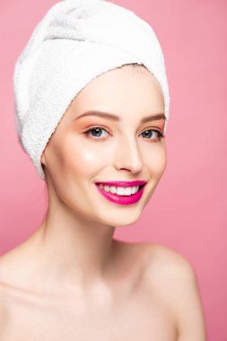 smiling nude woman in white towel isolated on pink 